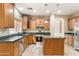 Kitchen featuring light-toned wood cabinets, stainless steel appliances and tile flooring at 3253 N 138Th Ave, Avondale, AZ 85392