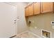 Functional laundry room with overhead cabinetry and ample space for appliances and storage solutions at 3253 N 138Th Ave, Avondale, AZ 85392