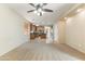 Bright living room with a ceiling fan flows into the kitchen at 3253 N 138Th Ave, Avondale, AZ 85392