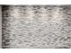 Close up of a stone accent wall with overhead spotlights at 3348 E Sequoia Dr, Phoenix, AZ 85050