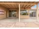 A covered patio features desert themed art, sliding glass doors and a ceiling fan at 3348 E Sequoia Dr, Phoenix, AZ 85050