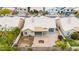 An aerial view of a backyard featuring a stone patio, small grass area, and block wall fence at 3348 E Sequoia Dr, Phoenix, AZ 85050