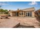 A large backyard features a covered patio, ample landscaping and mature trees at 3348 E Sequoia Dr, Phoenix, AZ 85050