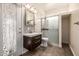 Well lit bathroom features a modern vanity, patterned tile shower and door to the outside at 3348 E Sequoia Dr, Phoenix, AZ 85050