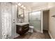 Bathroom featuring a vanity with a dark wood cabinet, tile backsplash, and glass shower at 3348 E Sequoia Dr, Phoenix, AZ 85050
