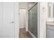 Bathroom view with a glass enclosed shower, tile surround, and door to separate closet space at 3348 E Sequoia Dr, Phoenix, AZ 85050