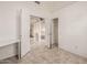 Bright bedroom with tiled floors, a closet and entrance to the en-suite bathroom at 3348 E Sequoia Dr, Phoenix, AZ 85050