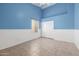 Bright bedroom showcasing tile floors, baseboards, and paneled walls at 3348 E Sequoia Dr, Phoenix, AZ 85050