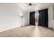 Spacious room with vaulted ceilings, tile floors, and access to a private patio at 3348 E Sequoia Dr, Phoenix, AZ 85050