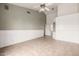Bright bedroom featuring a ceiling fan, tile floors, and white wainscoting at 3348 E Sequoia Dr, Phoenix, AZ 85050
