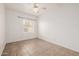 Neutral bedroom with tile flooring, a large window, and white walls at 3348 E Sequoia Dr, Phoenix, AZ 85050