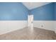 Bedroom with blue accent walls, tile flooring, baseboards, and paneled walls at 3348 E Sequoia Dr, Phoenix, AZ 85050