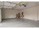 Spacious two car garage featuring clean epoxy floors and a door to the main house at 3348 E Sequoia Dr, Phoenix, AZ 85050