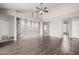 Spacious living room featuring wood floors and a stone accent wall at 3348 E Sequoia Dr, Phoenix, AZ 85050