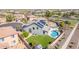 Stunning aerial view of a house featuring a pristine pool, lush backyard, and solar panels at 41581 W Somerset Dr, Maricopa, AZ 85138