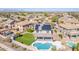 Aerial view of a home featuring a beautiful pool, green lawn and solar panels at 41581 W Somerset Dr, Maricopa, AZ 85138