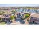 Beautiful aerial view of a home by a lake featuring solar panels, green lawn and immaculate landscaping at 41581 W Somerset Dr, Maricopa, AZ 85138