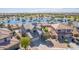 Beautiful aerial view of a home by a lake featuring solar panels, and mature desert landscaping at 41581 W Somerset Dr, Maricopa, AZ 85138