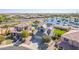 Beautiful aerial view of a home by a lake featuring solar panels and immaculate desert landscaping at 41581 W Somerset Dr, Maricopa, AZ 85138