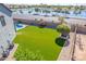 Backyard view featuring green turf, desert landscaping and view of community lake at 41581 W Somerset Dr, Maricopa, AZ 85138