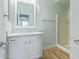 A well-lit bathroom features a glass shower, quartz countertop, and clean finishes at 41581 W Somerset Dr, Maricopa, AZ 85138