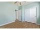Bedroom featuring wood-look floors and ensuite doors at 41581 W Somerset Dr, Maricopa, AZ 85138