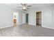 Bedroom with ceiling fan, closet and bathroom entrances, and wood laminate floor at 41581 W Somerset Dr, Maricopa, AZ 85138