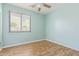 Bedroom with wood-look floors and a window at 41581 W Somerset Dr, Maricopa, AZ 85138