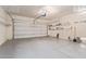 Spacious two car garage with ample shelving for storage and organization at 41581 W Somerset Dr, Maricopa, AZ 85138