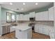 Bright kitchen featuring white cabinets, stainless steel appliances, and quartz countertops at 41581 W Somerset Dr, Maricopa, AZ 85138