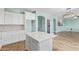 Kitchen with white cabinets, quartz countertops, walk-in pantry, and open floor plan at 41581 W Somerset Dr, Maricopa, AZ 85138