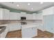 Bright kitchen featuring white cabinets, stone countertops, stainless appliances, and island at 41581 W Somerset Dr, Maricopa, AZ 85138
