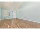 Bright, airy living room with vaulted ceilings, shuttered windows and wood-look tile flooring at 41581 W Somerset Dr, Maricopa, AZ 85138