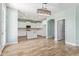 Spacious living room overlooking the kitchen with tile floors, light blue walls, recessed lighting, and backyard access at 41581 W Somerset Dr, Maricopa, AZ 85138