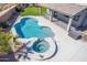 Beautiful blue pool with connected hot tub and covered patio area at 41581 W Somerset Dr, Maricopa, AZ 85138