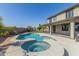 Beautiful pool and spa combination with views of the backyard and blue skies above at 41581 W Somerset Dr, Maricopa, AZ 85138