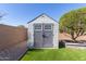 Backyard shed with double doors and gable roof at 41581 W Somerset Dr, Maricopa, AZ 85138