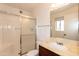 Bright bathroom featuring a vanity, toilet and walk in shower with shower doors at 4227 E Yowy St, Phoenix, AZ 85044