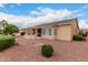 Spacious backyard featuring a covered patio and landscaping in a xeriscaped yard at 42911 W Magic Moment Dr, Maricopa, AZ 85138