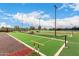Well-maintained bocce ball court with lush landscaping, perfect for outdoor recreation and friendly competition at 42911 W Magic Moment Dr, Maricopa, AZ 85138