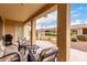 Inviting covered patio with comfortable seating and outdoor grill, perfect for relaxing and entertaining guests at 42911 W Magic Moment Dr, Maricopa, AZ 85138