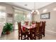 Inviting dining room featuring a rustic wood table, chairs, and sliding glass doors to backyard at 42911 W Magic Moment Dr, Maricopa, AZ 85138