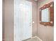 Bright entryway featuring a white front door, neutral walls, and a decorative mirror, creating a welcoming space at 42911 W Magic Moment Dr, Maricopa, AZ 85138
