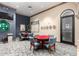 Well-appointed game room featuring poker tables, chairs, and decorative accents for recreation and entertainment at 42911 W Magic Moment Dr, Maricopa, AZ 85138