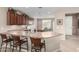 Spacious kitchen with ample counter space, stylish chairs at the bar, and modern appliances at 42911 W Magic Moment Dr, Maricopa, AZ 85138