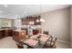 Open kitchen with dining area, updated appliances, and a kitchen island at 42911 W Magic Moment Dr, Maricopa, AZ 85138