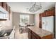 Charming kitchen with an island, updated appliances, and an adjacent dining area at 42911 W Magic Moment Dr, Maricopa, AZ 85138