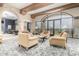 Comfortable lounge area with cozy armchairs, coffee tables, and large windows with community views at 42911 W Magic Moment Dr, Maricopa, AZ 85138