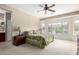 Serene primary bedroom with large windows, carpet, and en-suite bathroom access at 42911 W Magic Moment Dr, Maricopa, AZ 85138