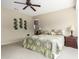 Comfortable primary bedroom offering natural light, neutral walls and carpet at 42911 W Magic Moment Dr, Maricopa, AZ 85138